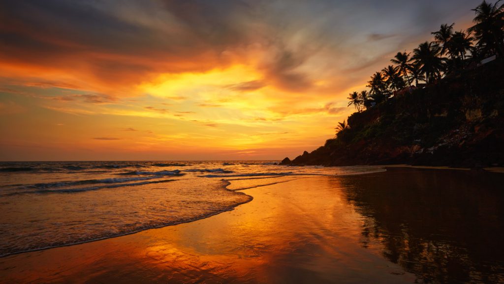 A picturesque view of Sunset on Varkala beach, a popular tourist destination in Kerala
