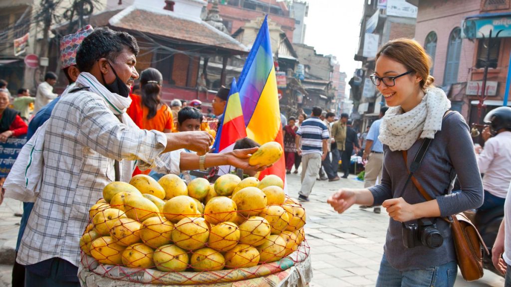 An unidentified woman buys mangoes at the markets of Varanasi.