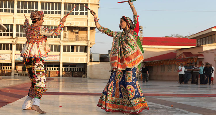 Two dancers preforming Dandiya Raas dance on the occasion of Navratri festival.